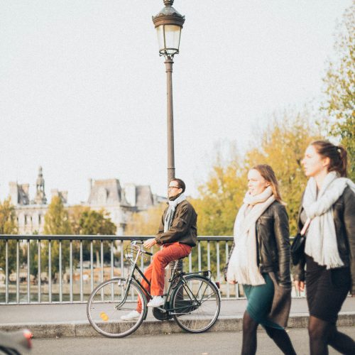 People walking and riding bikes in a city; Photo by Elina Sazonova of Pexels